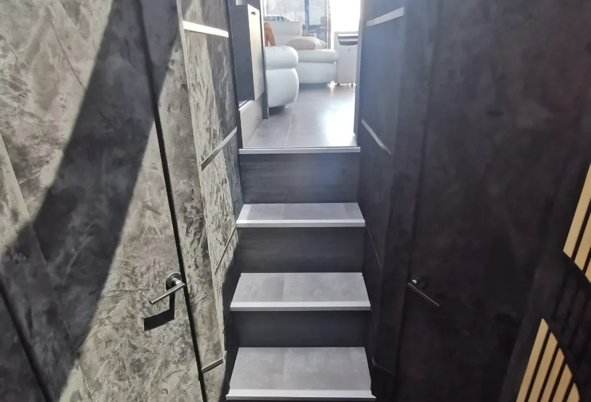 Lower deck hallway on a Marbella charter yacht with doors leading to cabins and bathroom.