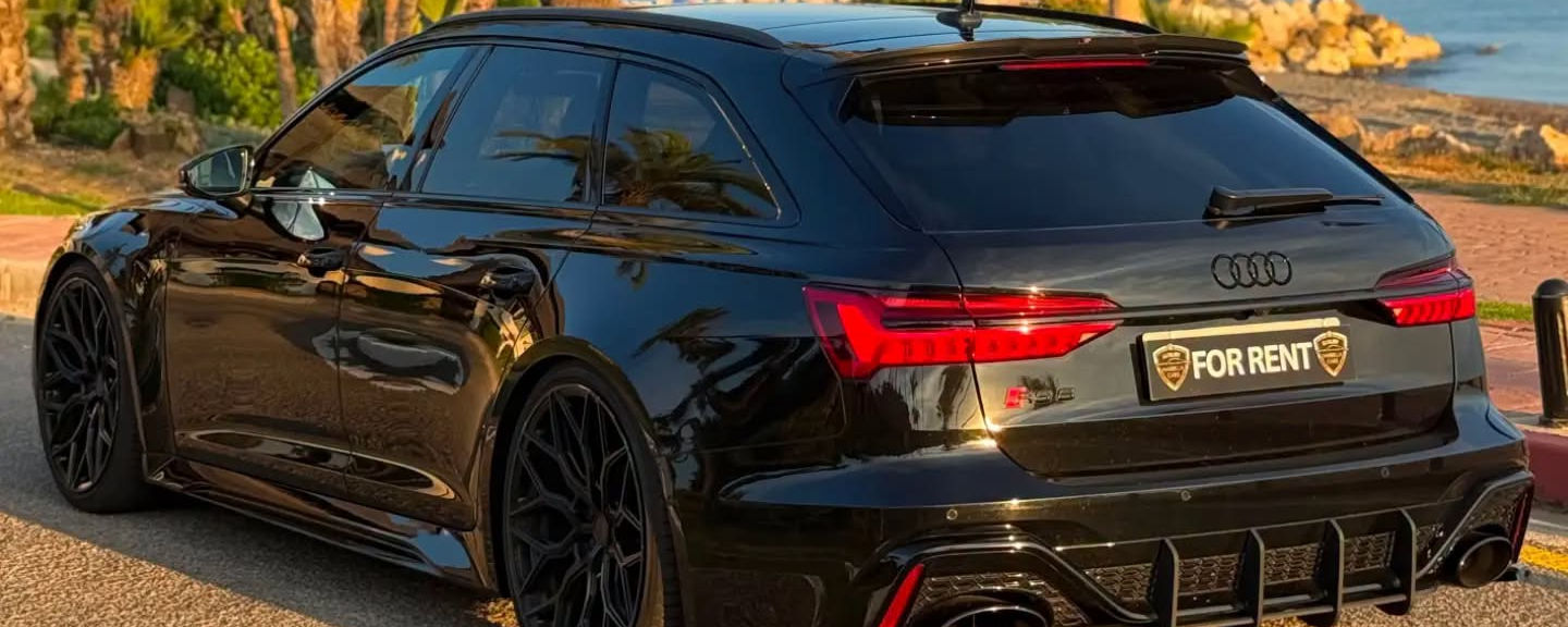 Audi RS6 Avant parked beside the Marbella coastline
