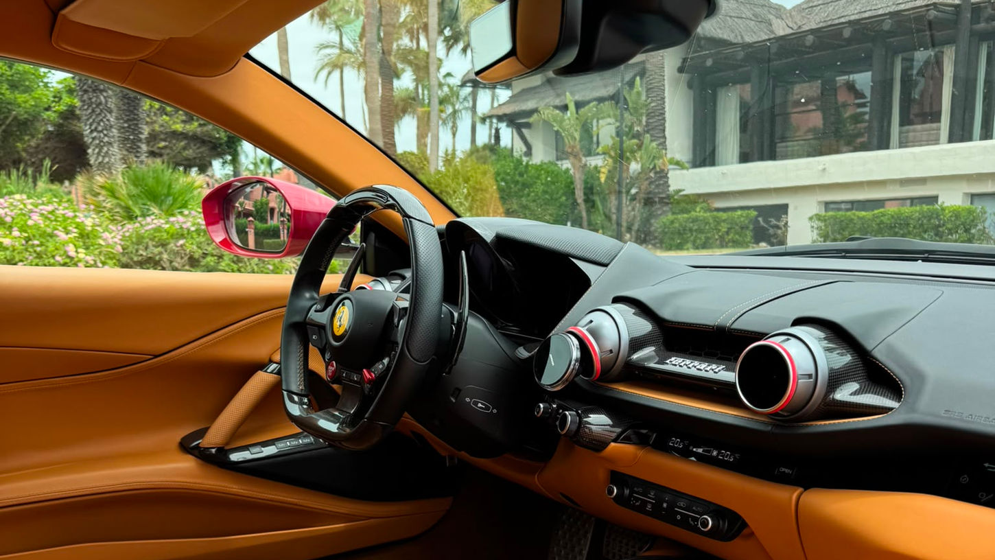 Luxury tan leather interior of Ferrari 812 Superfast rental in Marbella featuring carbon fibre trim and premium finishes