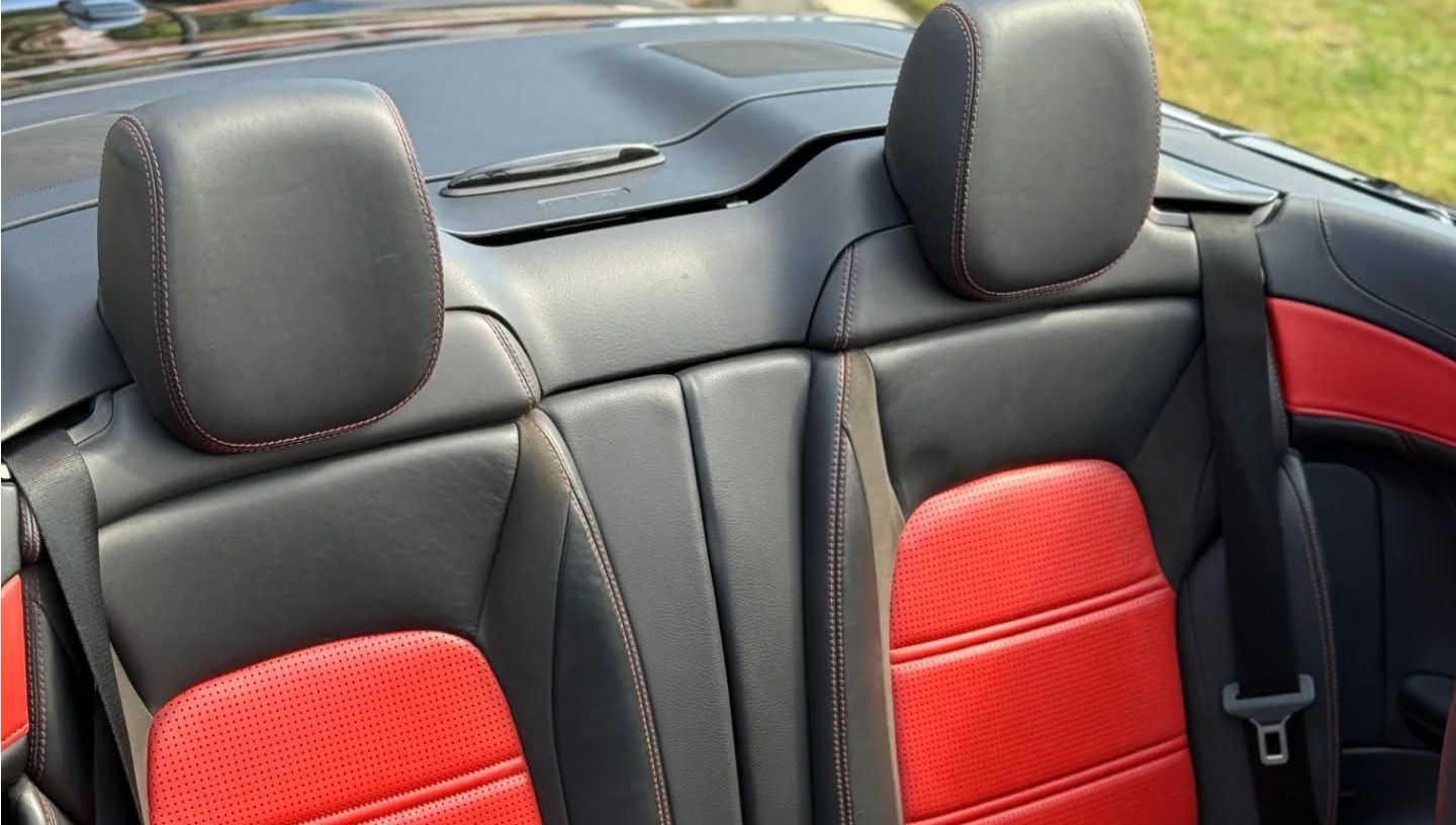 Rear seats of Mercedes-AMG C63 S Cabriolet with individual cushions, integrated headrests and quality leather upholstery, compact yet premium back seats for Marbella cabrio rental