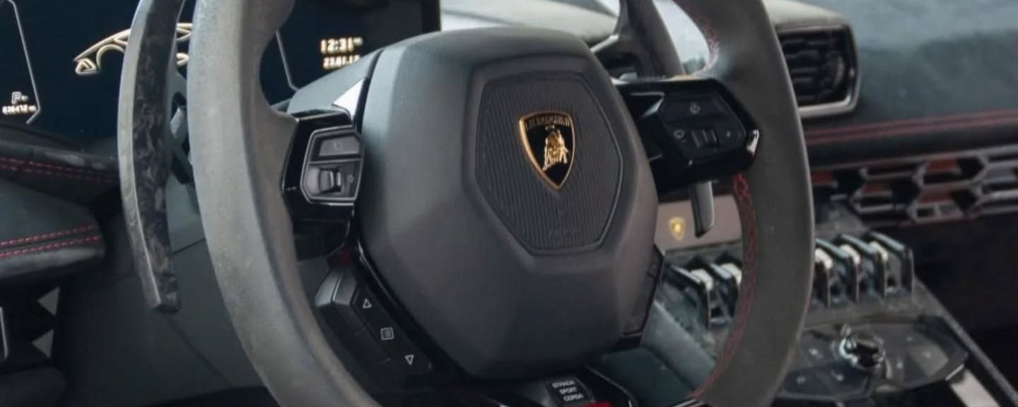 Lamborghini Huracán steering wheel with performance controls in rental vehicle