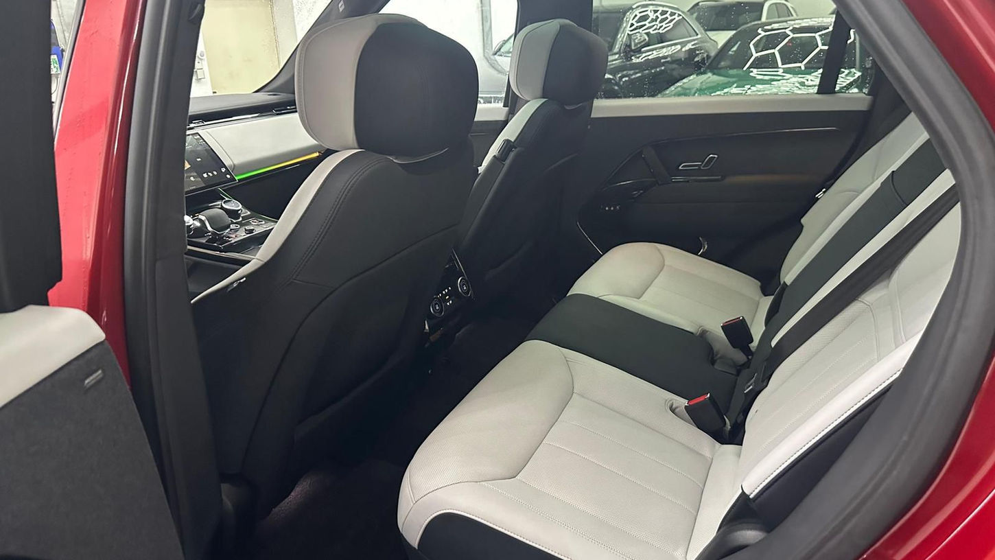 Spacious rear seating area of Range Rover Sport featuring premium leather comfort and luxury travel space
