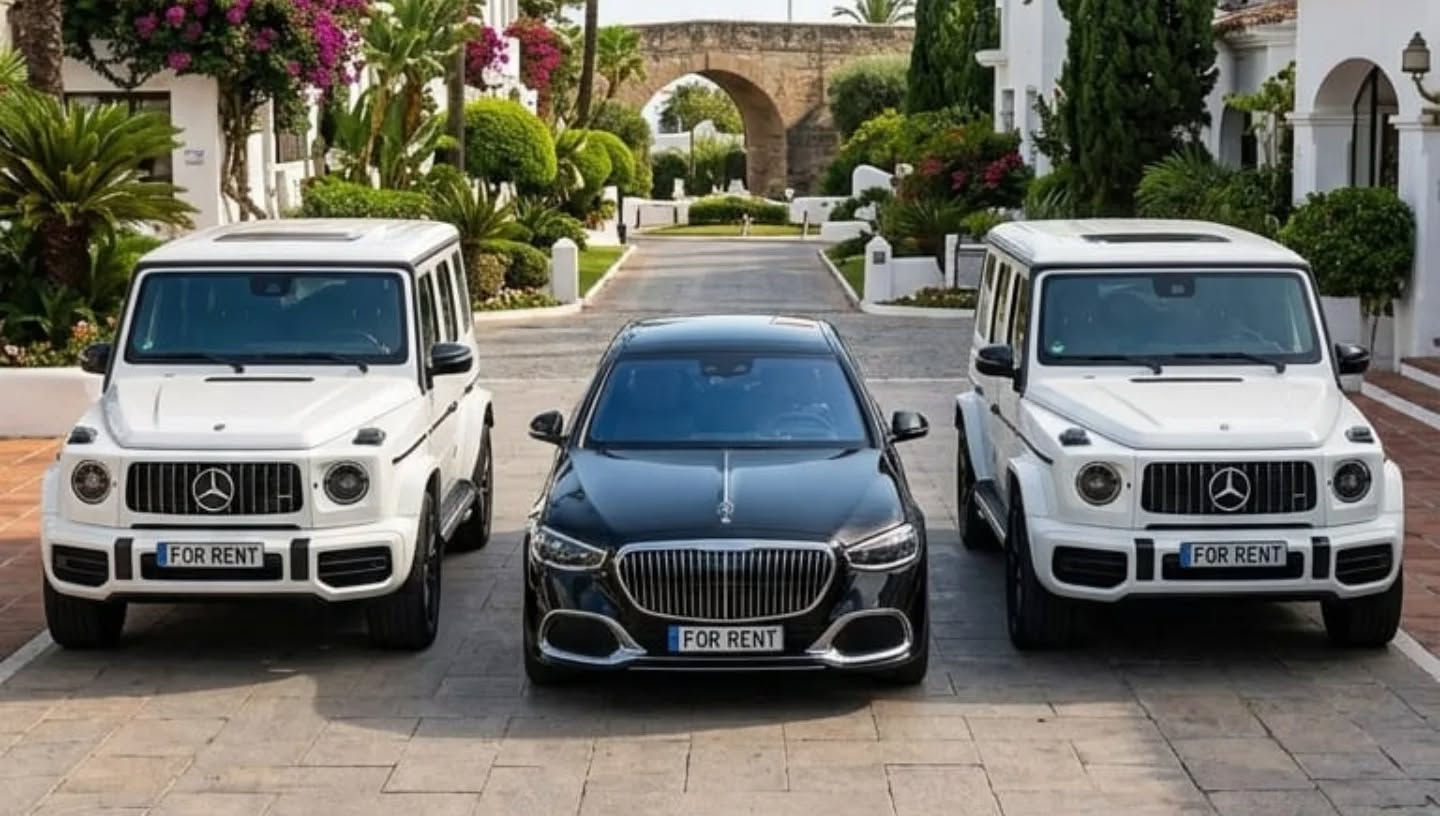 Wide shot of black Mercedes-Maybach S680 parked between two white Mercedes-AMG G63 SUVs, showcasing full Apex Drive luxury fleet in Marbella
