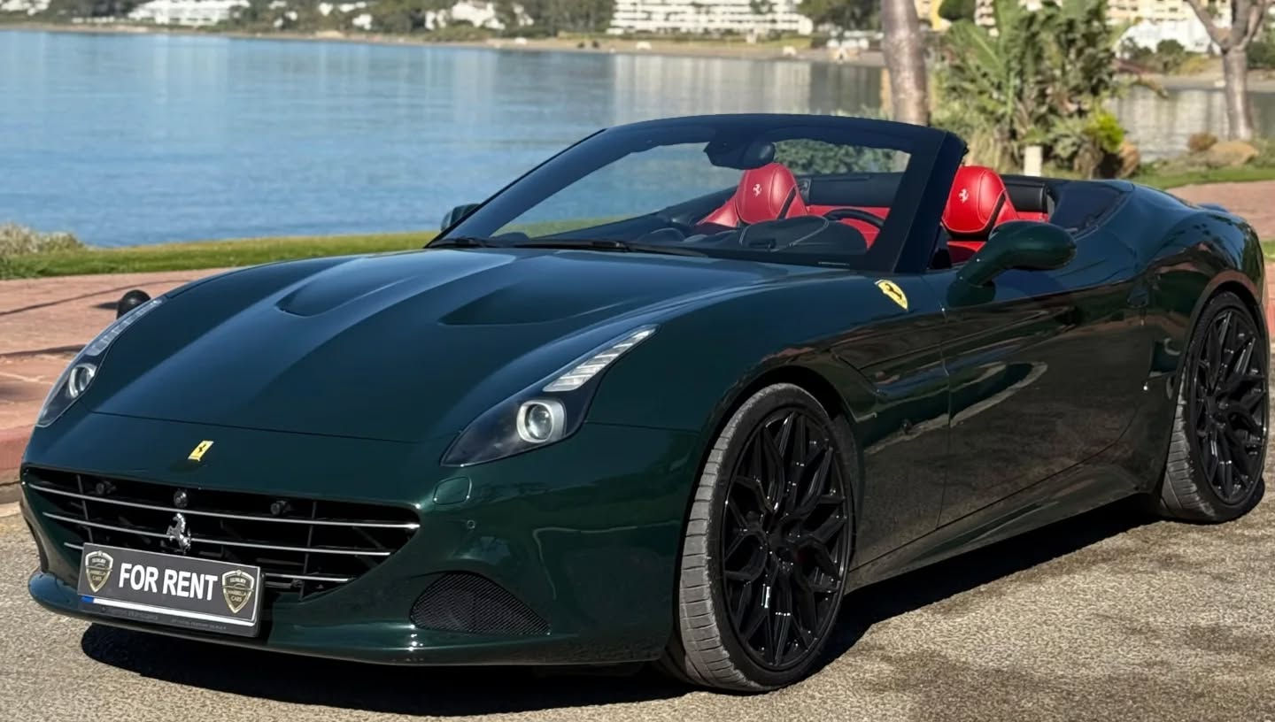 Detailed front-left corner angle showcasing Prancing Horse grille badge, aerodynamic side vents, quad LED headlights and sculpted muscular fender on Ferrari California T convertible grand tourer, luxury SUV rental Marbella