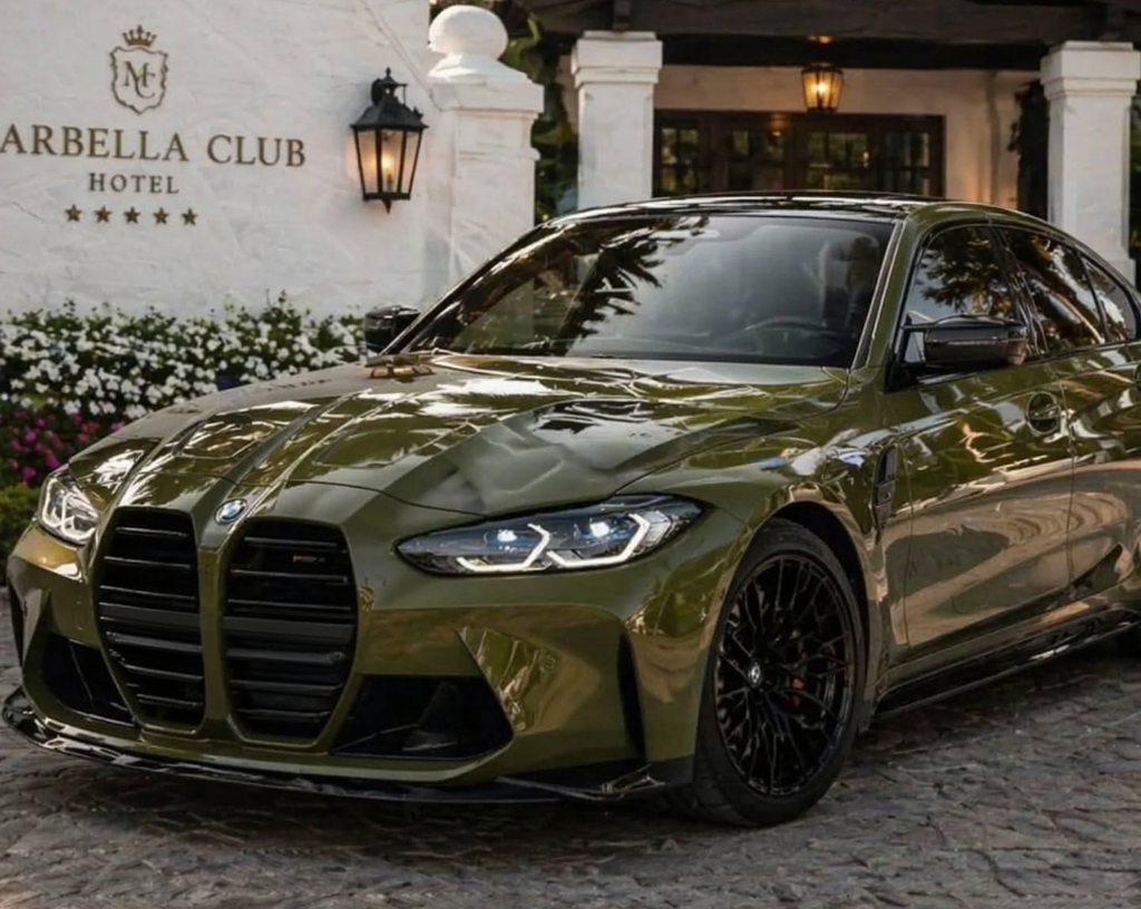 Front left three-quarter hero view of BMW M3 Competition 523 hp sports sedan parked outdoors, showing aggressive front bumper and kidney grilles.