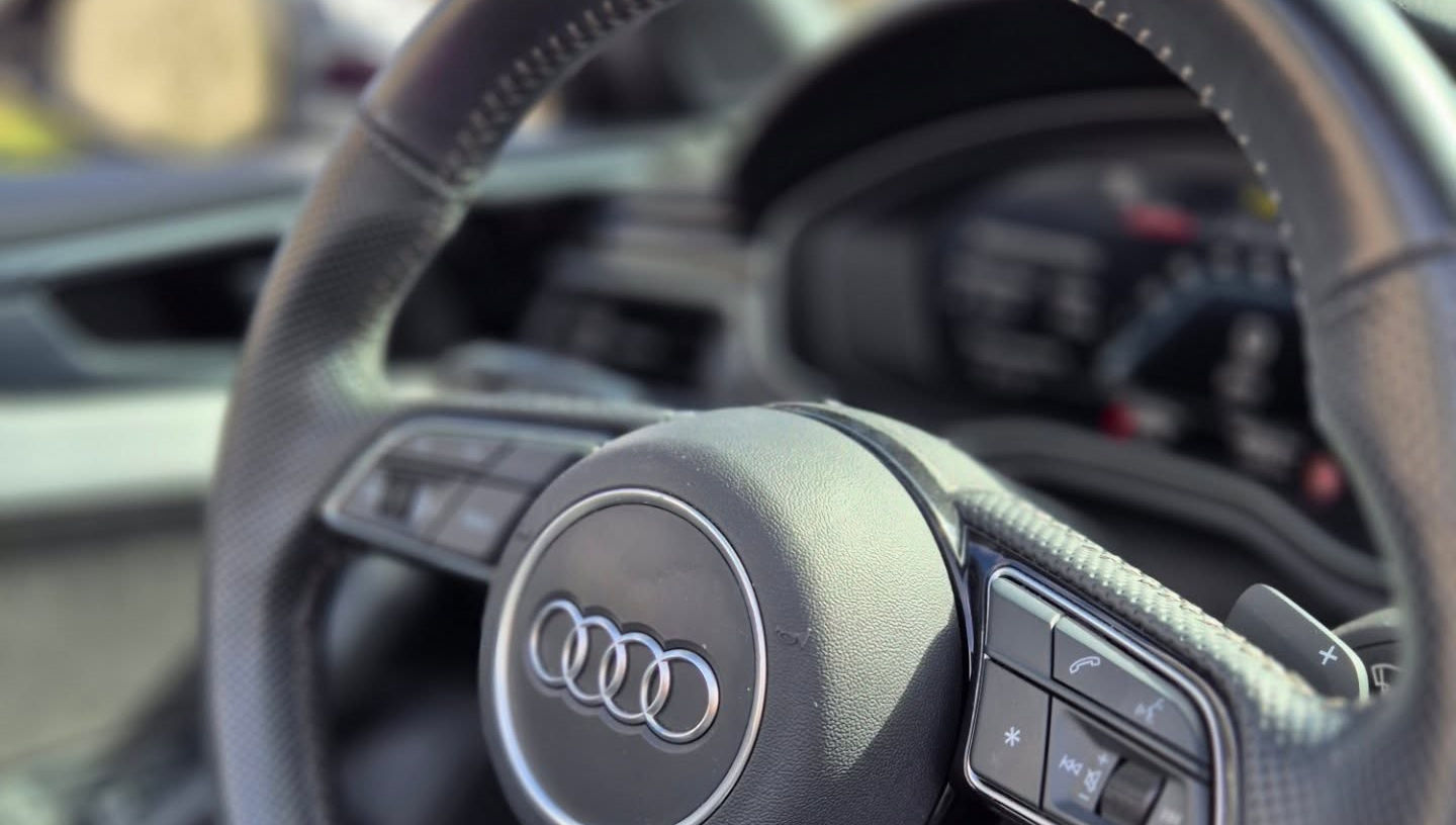 S sport flat-bottom steering wheel with aluminum shift paddles and S5 badge in Audi S5 Cabriolet, Marbella rental