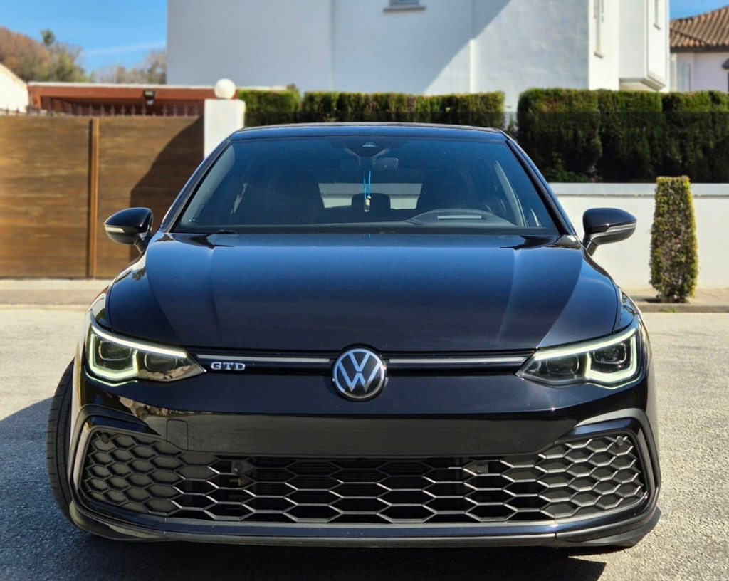 Head-on front view of black VW Golf GTD showing GTD grille badge, sharp headlamps and aggressive lower air intakes, VW Golf hire Marbella