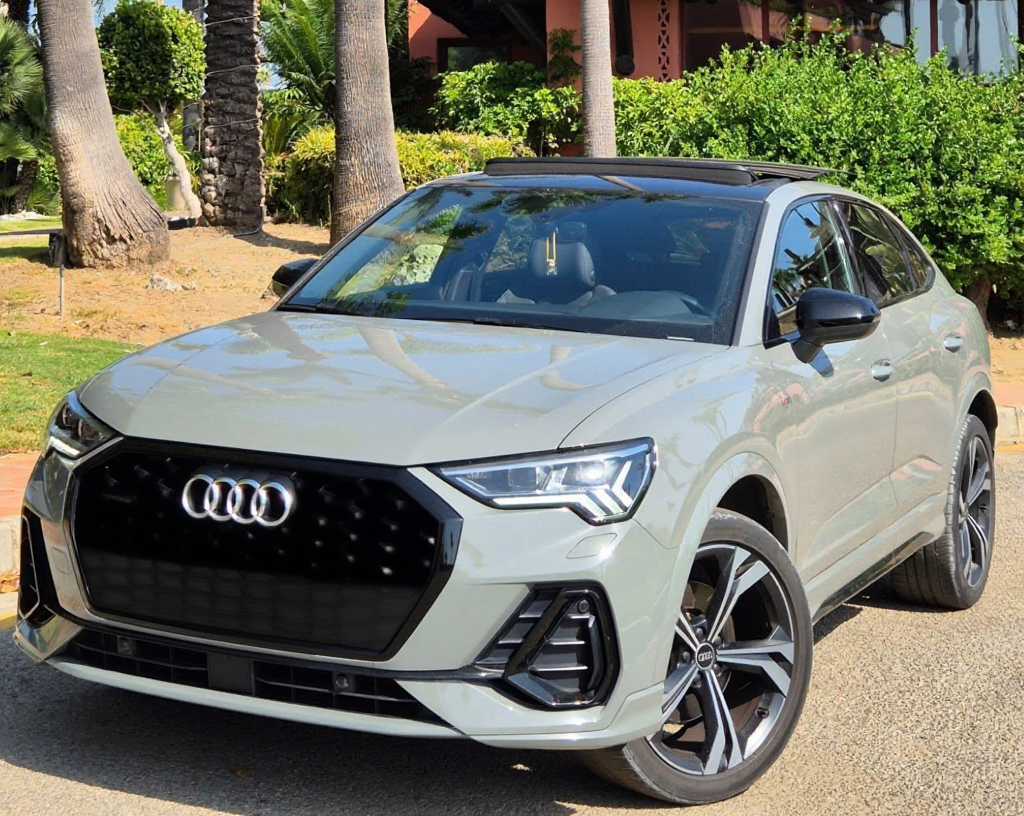 Front left three‑quarter hero view of Audi Q3 S‑line TDI compact SUV parked outdoors in Marbella, showing S line styling and LED headlights.