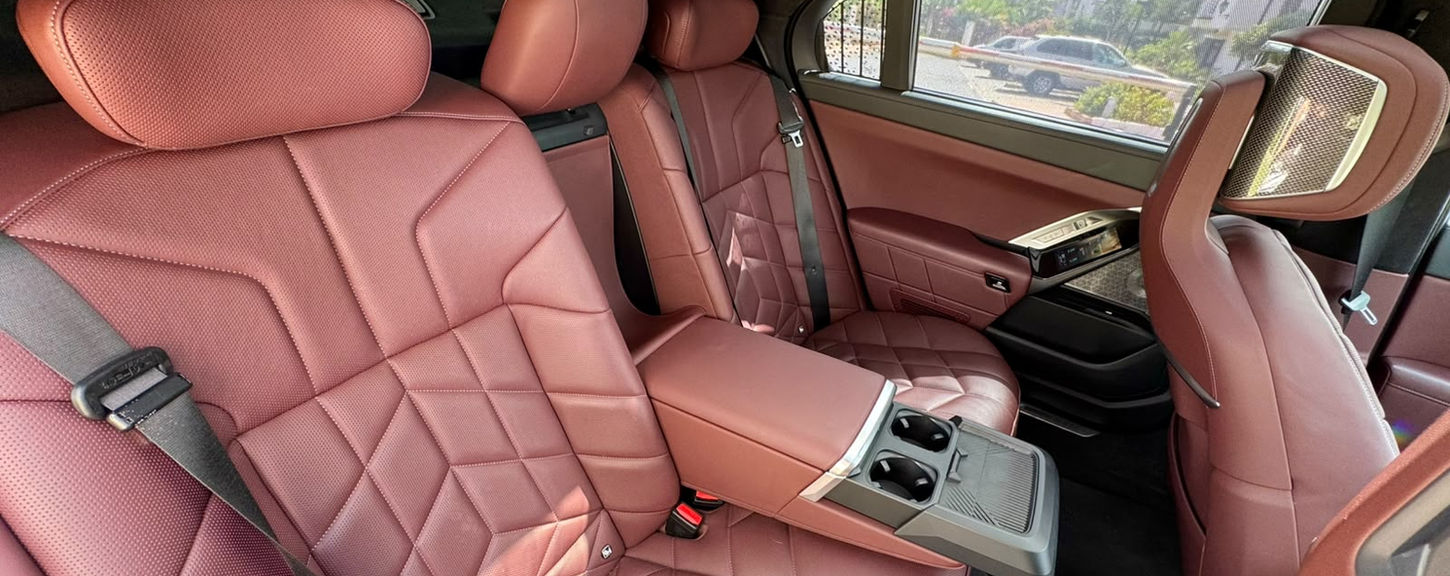 BMW 750e rear leather seats with folding centre armrest and luxury cabin finish.