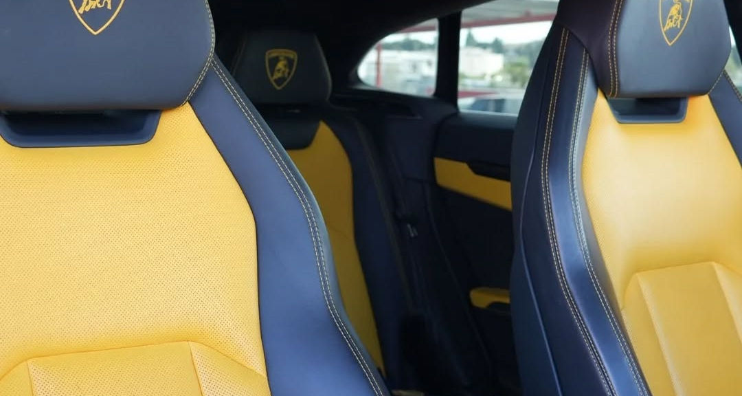 Interior view of Lamborghini Urus showing both front and rear seats with premium leather upholstery and spacious cabin layout.
