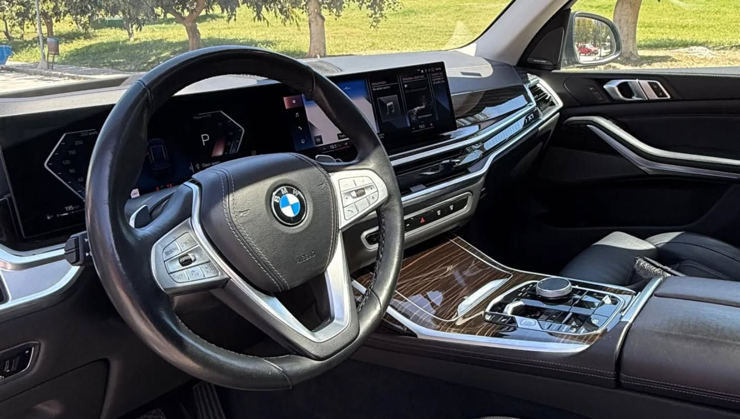 BMW X7 dashboard with digital display and premium controls in rental vehicle