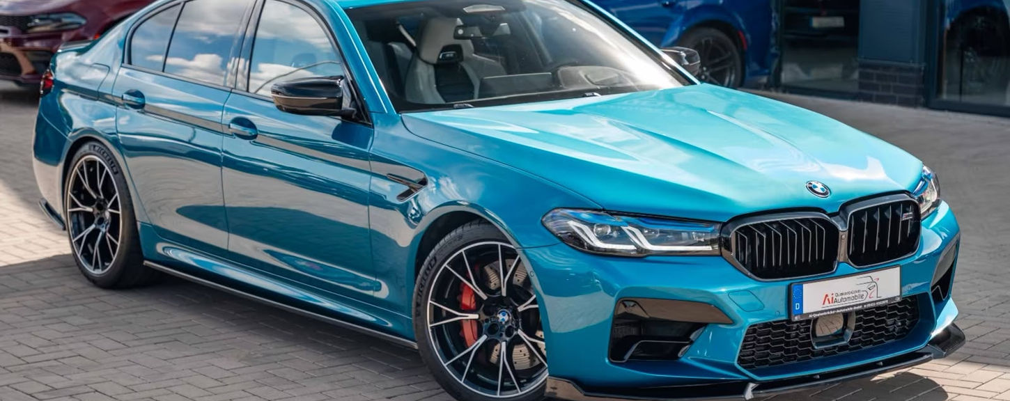 Side profile of the BMW M5 Competition parked in Marbella, available for executive and performance car rental.