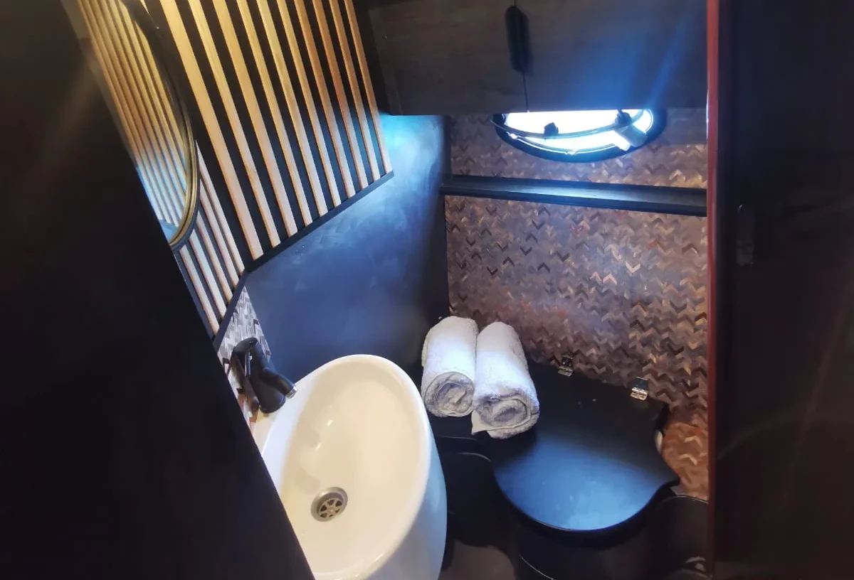Bathroom on a Marbella charter yacht with sink, mirror and shower in a compact, modern layout.