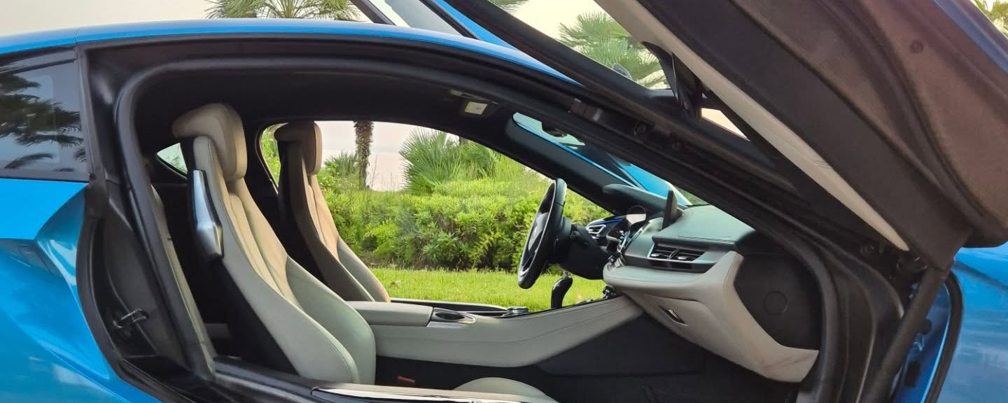 Side view of BMW i8 with butterfly door open in Marbella