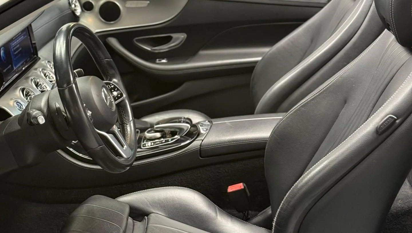 Front interior of Mercedes E-Class Cabriolet with premium finishes and modern technology