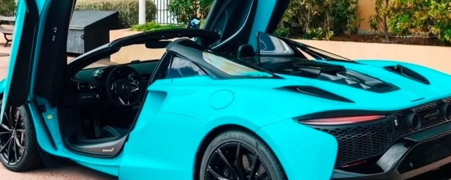 Rear left side view of McLaren Artura with dihedral door open in Marbella