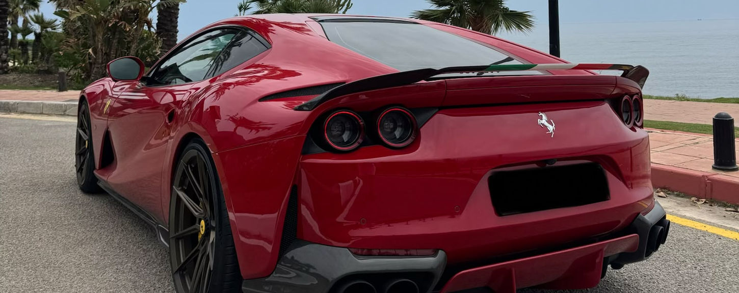 Ferrari 812 Superfast Novitec parked along Marbella coastline available for luxury supercar rental