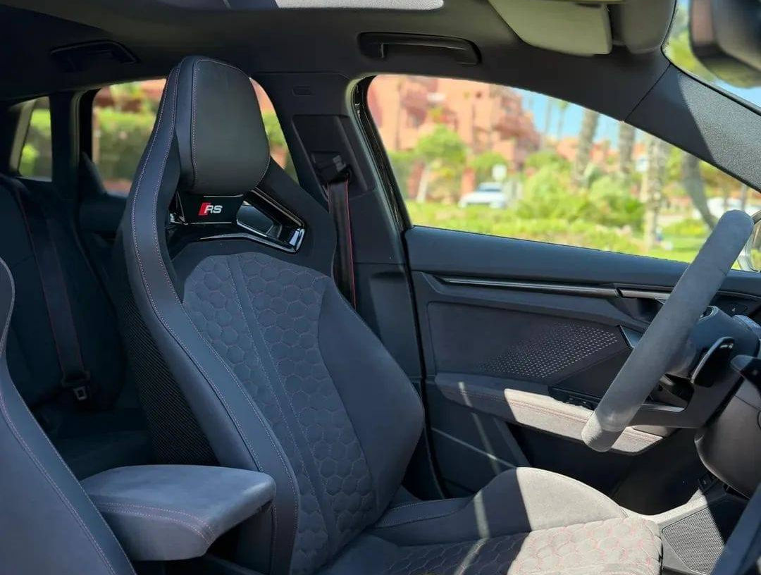 Driver's seat view of the Audi RS3 performance sedan featuring racing-inspired bucket seats