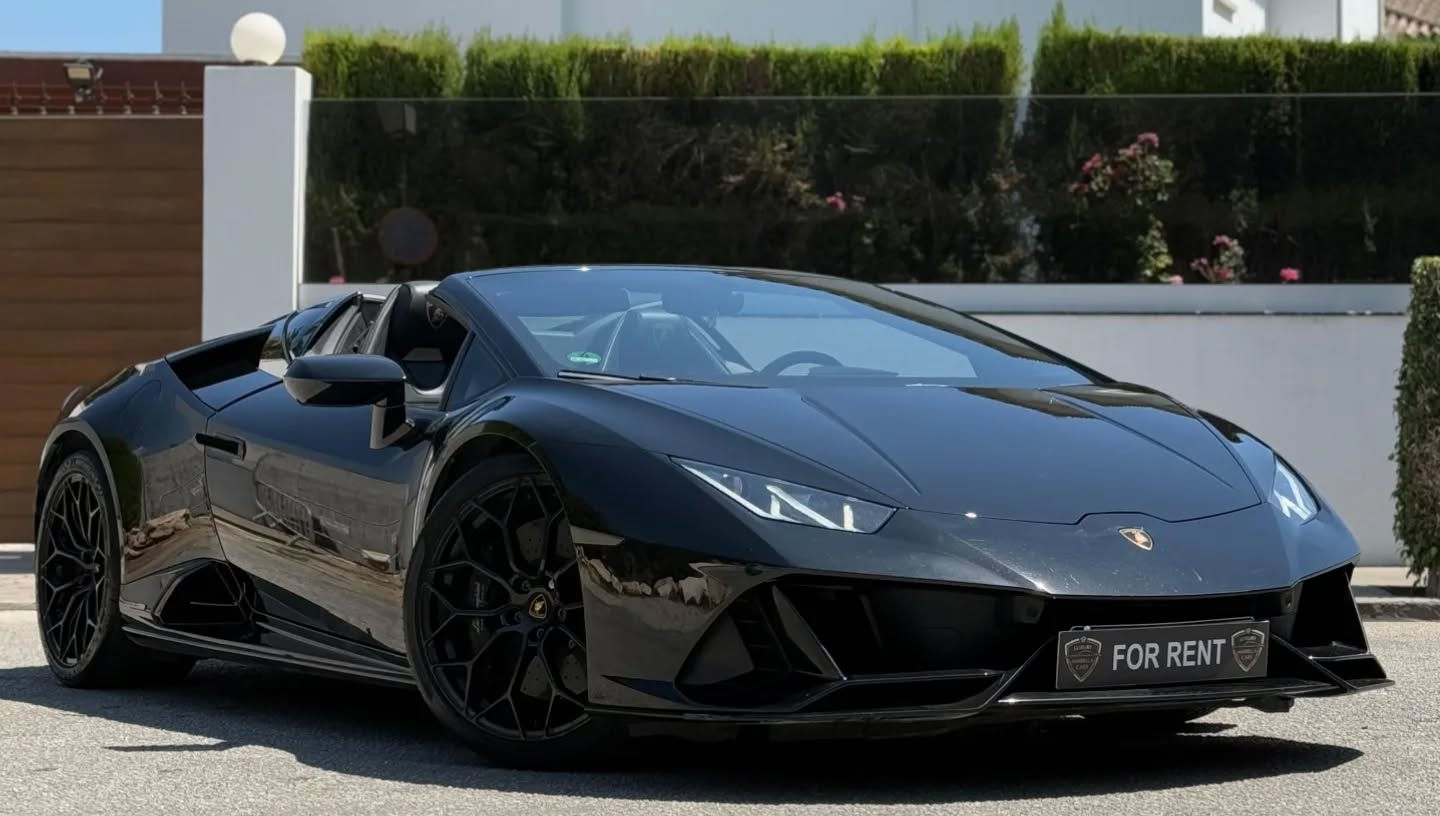 Front-right three-quarter view of black Lamborghini Huracán EVO Spyder with roof down, Y-shaped LED headlights, sharp front bumper and low aggressive stance, Marbella supercar rental
