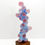 Thumbnail: A sculpture by Ralph Paquin, "Pink Gene Column" explores organic abstraction with pink and blue organic forms.