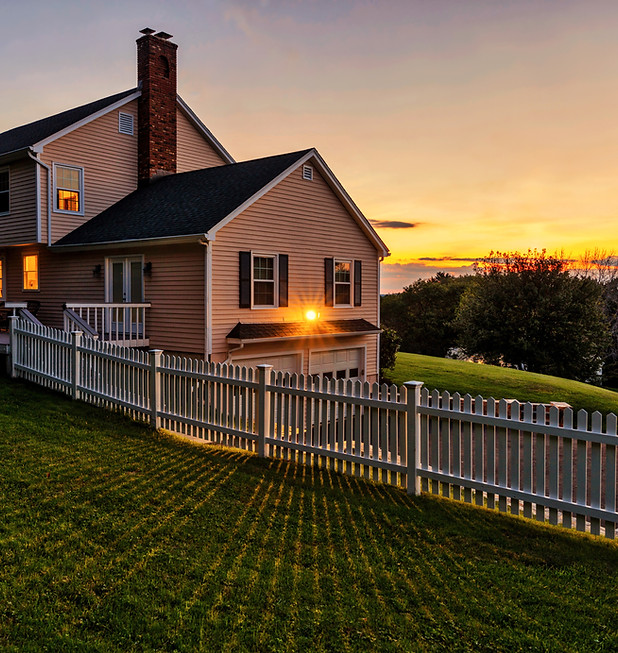 picket fence with home has new roof