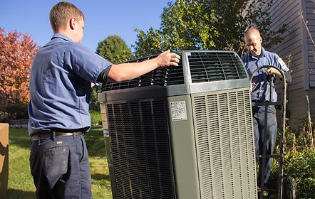 Two people moving outdoor unit