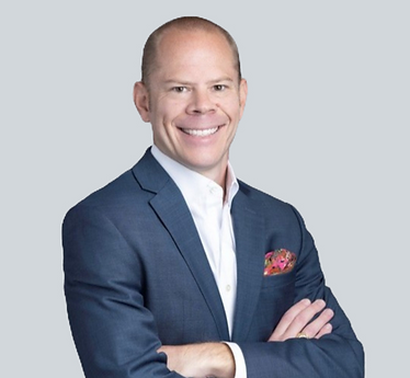 Headshot of Kyle Wardlaw, financial advisor, smiling, blue suit