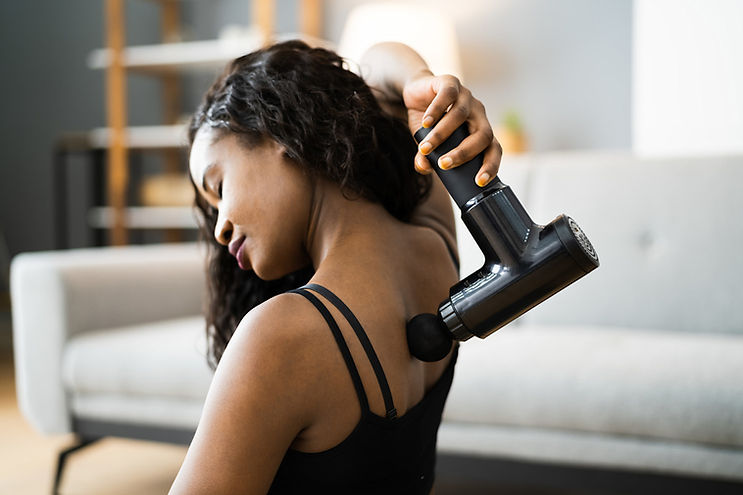 woman-using-massage-gun-in-her-back.jpg