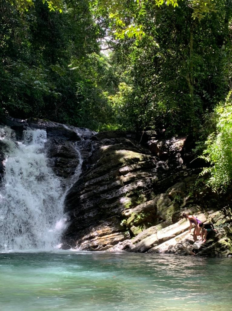 Diving from the rocks at Pozo Azul waterfall in Uvita Costa Rica