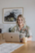 Julia Blair, Online Business Manager, working on her laptop in a bright workspace