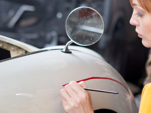 Panel beater technician answering customer FAQs