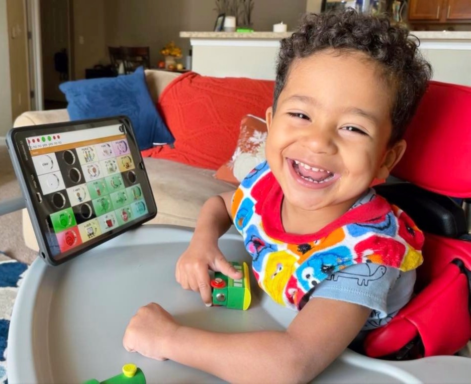 Child using a communication device during therapy