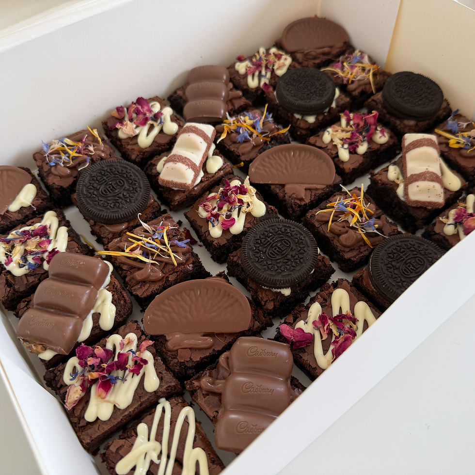 High angle view of a wedding dessert table featuring a brownie stack and floral decorations