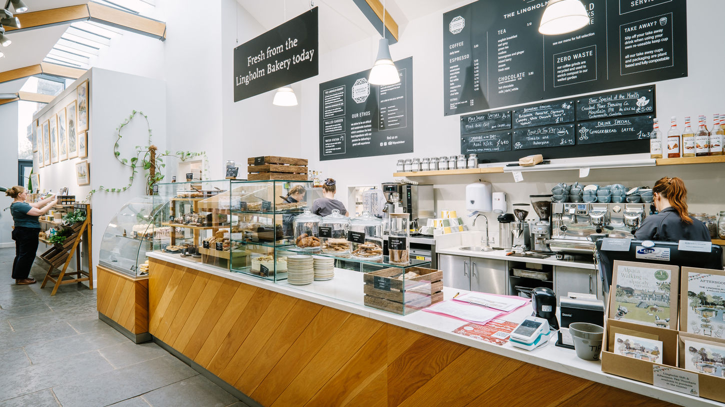 Cafe counter with fresh bakes and signage on the wall for menu at the Lingholm Kitchen