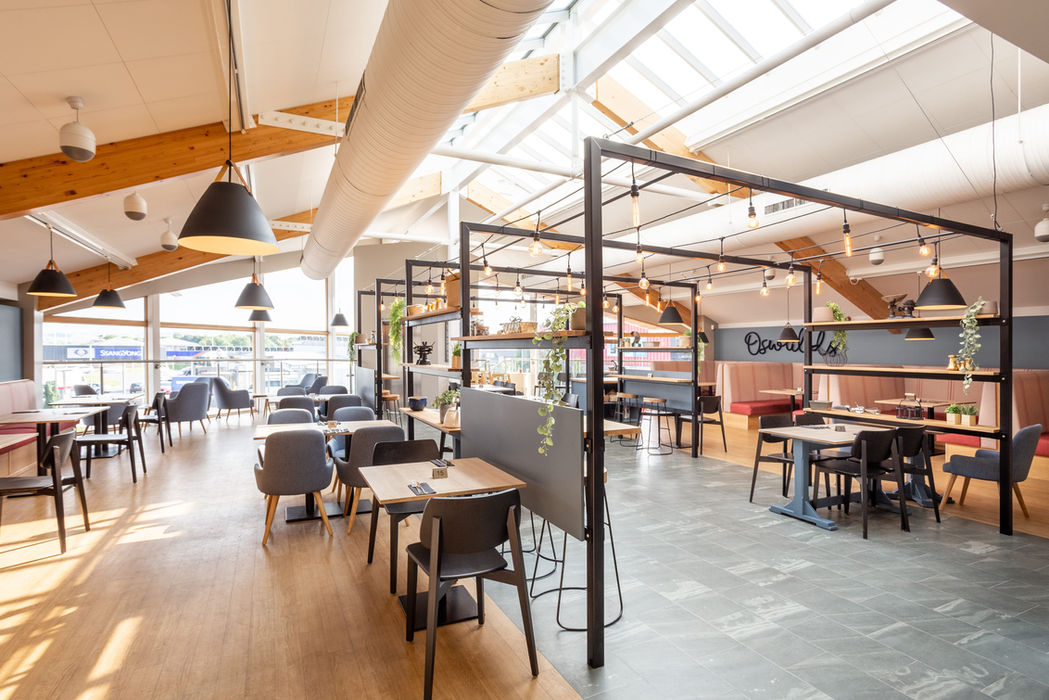 Customer seating and metal frame design with industrial lighting at Cafe Oswalds at Penrith Foodhall