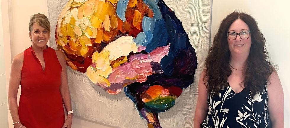 Betty Jean and Kelly are standing along side a beautiful mosaic of the brain.