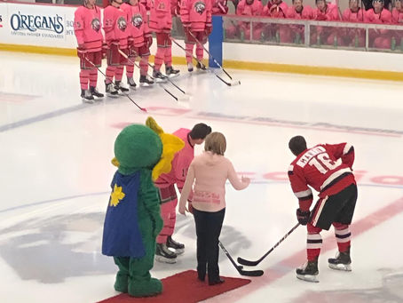 Betty Jean is dropping the puck at a hockey game in support of Breast Cancer.