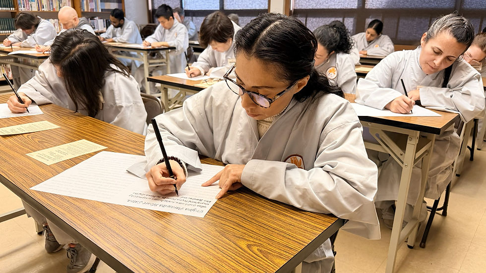 Participants focus their minds by transcribing the English Heart Sutra, deepening their understanding of the teachings. (Photo by Zhang Yin)