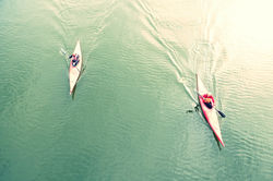 High Angle View Of People Kayaking In Lake