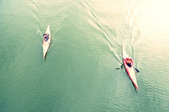 High Angle View Of People Kayaking In Lake