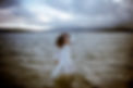 Senior girl standing in the water at Chazy Lake Beach in Dannemora, NY.