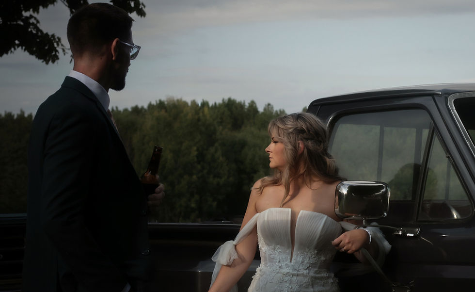 An Adirondack Bride and Groom stand by their antique ford truck after their wedding ceremony