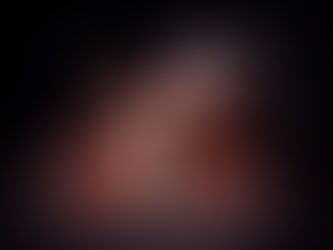 A photo of a bride and groom on the roof of a hotel, with fire swirling around them and a sign that says _hot Sara_ during winter wedding at Hotel Saranac