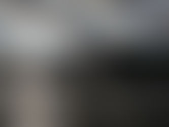 An Adirondack Coast wedding photo of a bride and groom walking on a dock on Lake Champlain with her veil in the wind in late fall