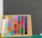 Cork board with swatches of fabric pinned on, in front of a black foam board