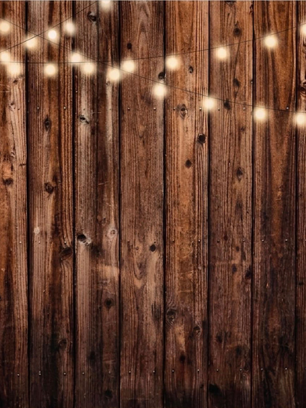Rustic wood backdrop with glowing string lights