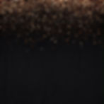 A solid matte black background illuminated by a delicate cascade of glowing golden stardust sparkles.