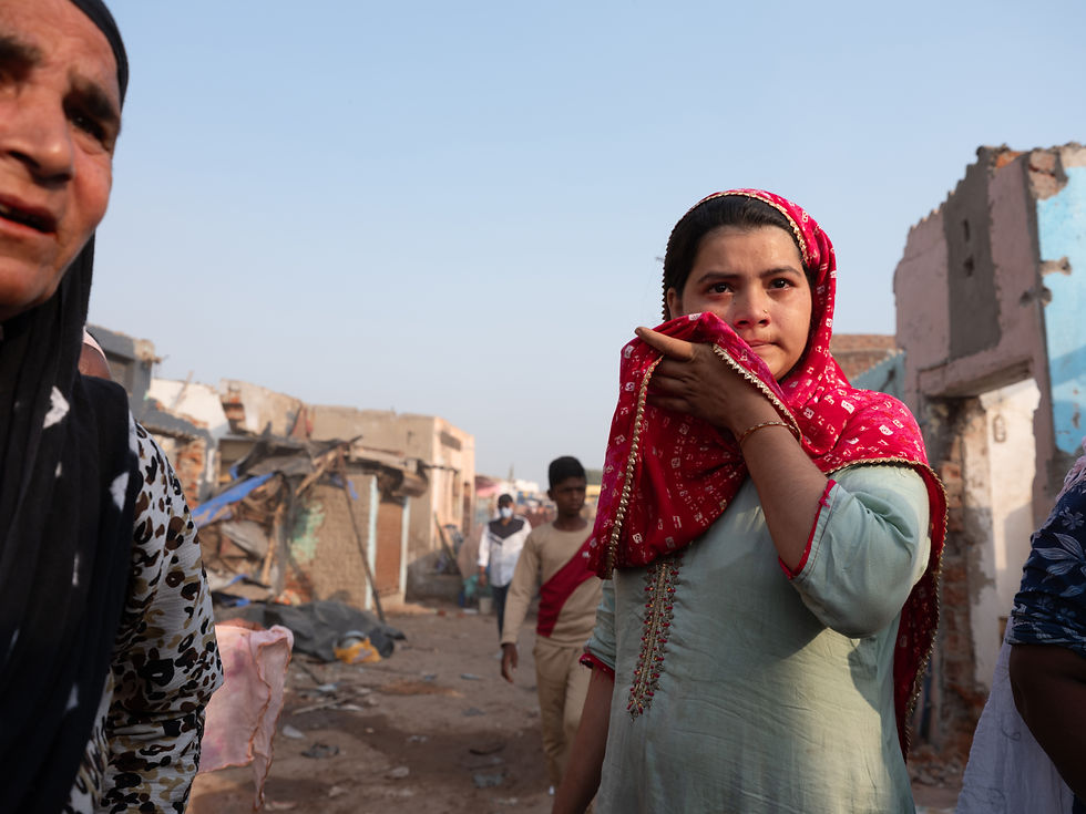 Parveen Ismail Rangrez, 28, witnesses her home in Chandola Lake being bulldozed in front of her. She said everything is wiped out now. (Zishaan Latif/For The Washington Post)