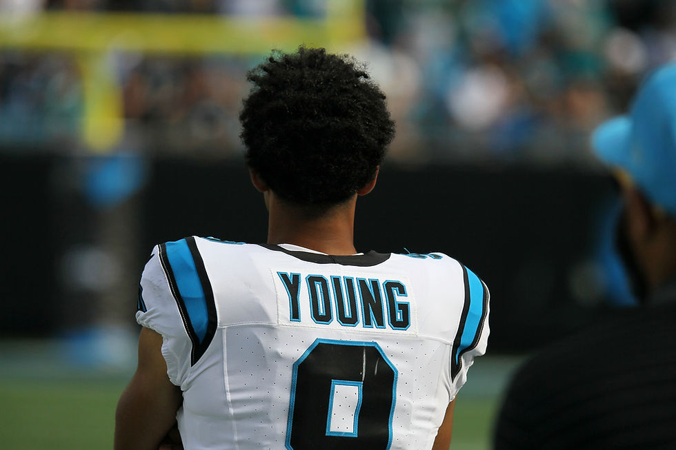 Bryce Young looks on from the sideline