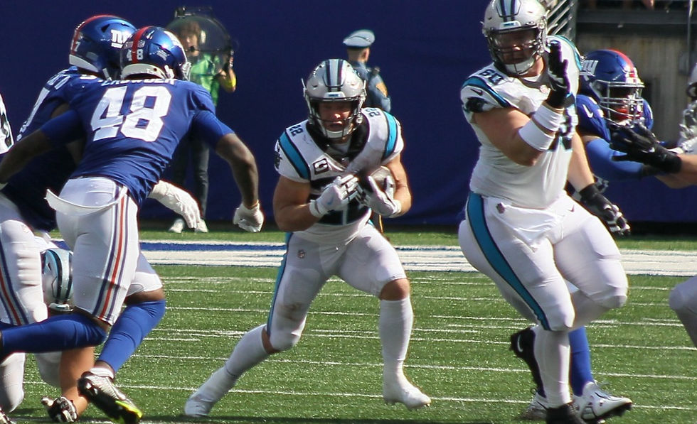 Christian McCaffrey attempts to run through the tackles during the Panthers against the new York Giants in 2022